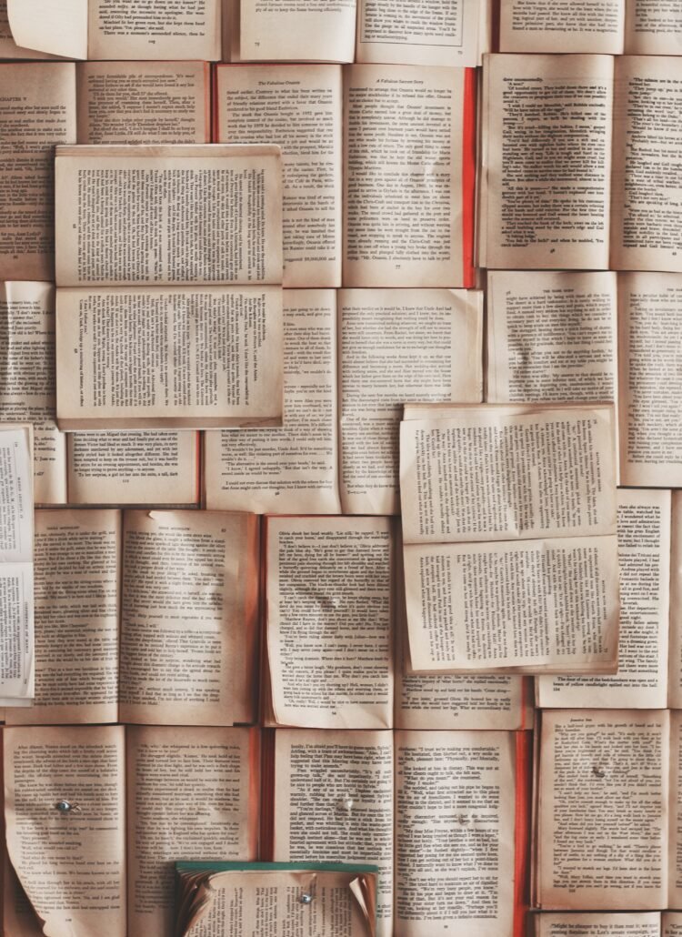 a floor covered in open books